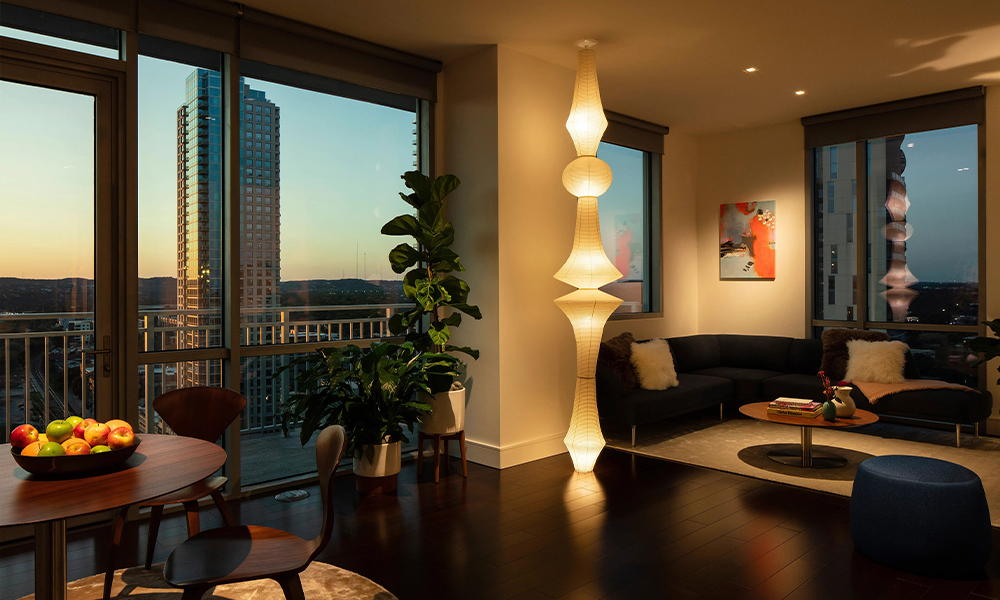 Josh AI Touch panel in a able with a traditional home in the background